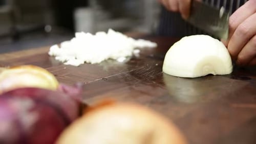 Chopping Onions on a Wood Cutting Board