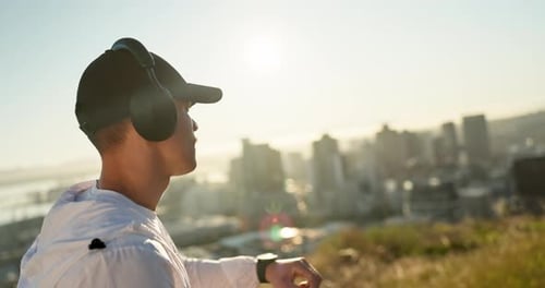 Young Adult Checking Watch Overlooking City on Sunny Day