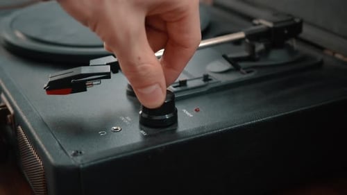 Hand Turns on Classic Black Record Player