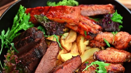 Grilled Meat Platter with Potatoes and Greens