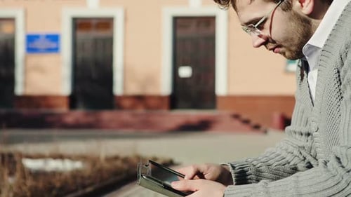 Close Up Young Man Hand Using Tablet in Town