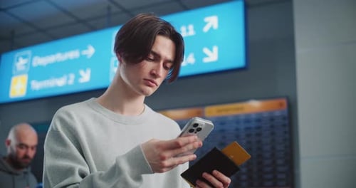 Crowded Airport Terminal Young Man Scanning Plane Ticket Using Phone to Check Flight Information