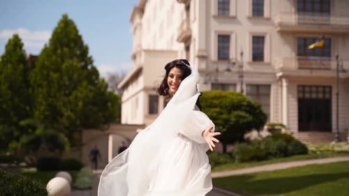 Happy Woman in Wedding Dress Posing Outdoors