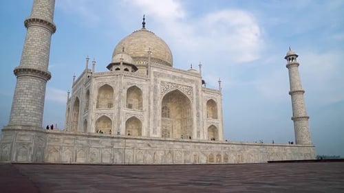 panoramic view of taj mahal UNESCO site morning ligh sunrise on the white marble arch