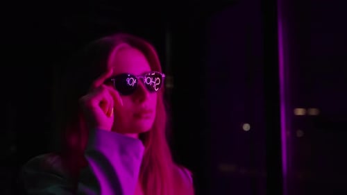 Stylish Woman Posing in Sunglasses at Night