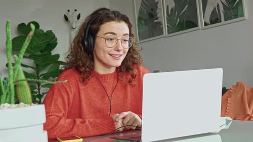 Woman Video Conferencing at Her Home Office