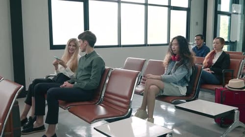 Passenger traveler people with luggage suitcase sitting on airport chair waiting for air travel