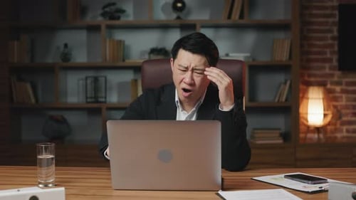 Frustrated Man Gesturing No at Computer in Office
