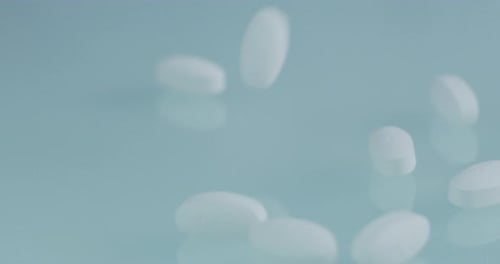 Slow motion of pills dropping on a white bench in a pharmacy or laboratory. Concept: chemistry, La