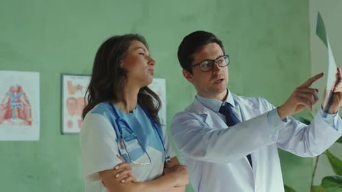Team of Medical Workers Cooperating in the Private Clinic Office Doctor and Nurse Discussing Therapy