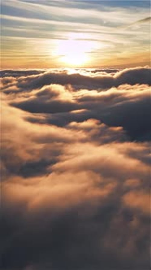 Vertical Aerial View of Flying above Misty Clouds Heaven at Golden Sunrise
