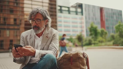 Man Using Smartphone in Urban Setting