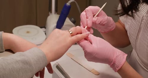 Woman Receives Manicure at Nail Salon, close up