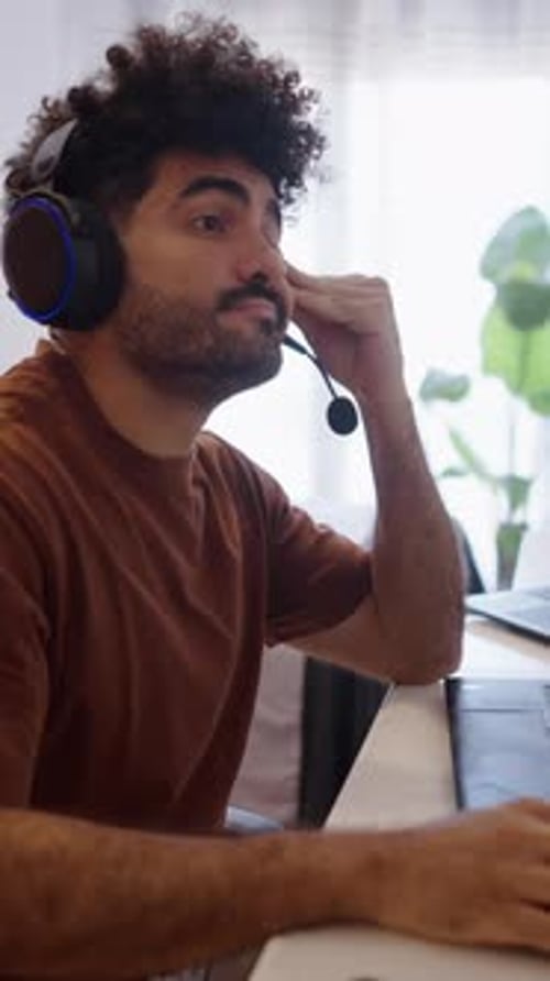 South American Boy Picks Up His Mobile Phone and Gets Up From His Work Chair
