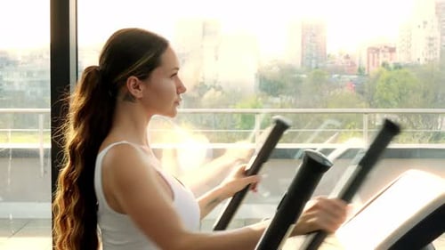 Attractive Girl Doing Cardio Workout in Fitness Center or Gym Selective Focus Health and Fitness