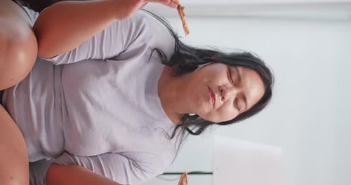 Woman Eating Pizza at Home, Close Up Vertical