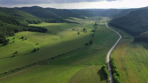 Amazing wide landscape with mountains on the side. Sun peeking through clouds. Hungary
