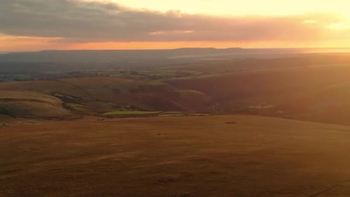Beautiful Golden Hour Sunset Across Welsh Countryside near Swansea with Rolling Hills and Fields