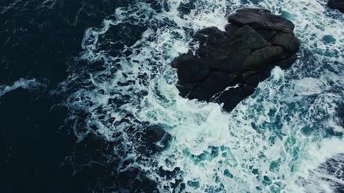Waters of the Ocean Swirl Around the Rocky and Scenic Coastline Sea Waves Breaking Over Rocks