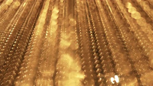Glitter movement of long gold chains. Uniform swing Slow smooth. Gold background for relaxation