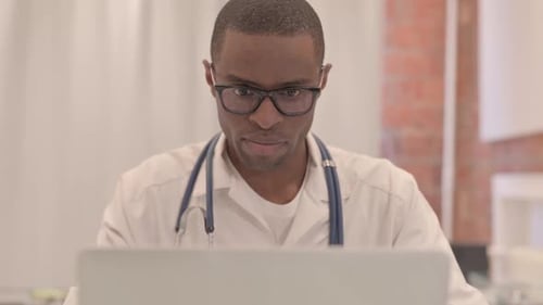 Close Up of Doctor Working on Laptop