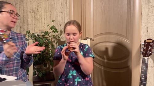 Girl Plays Ocarina with Musical Accompaniment