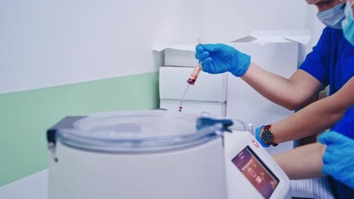 Medical Professionals Processing Blood Sample in Lab