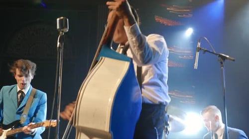 Male Rock Musicians Performing on Stage in Nightclub Arts Entertainment