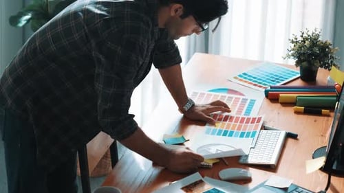 Graphic Designer Working on Laptop in Home Office