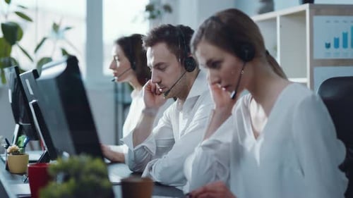 Close Up View of Line of Professional Customer Support Male and Woman Synchronically Answer the