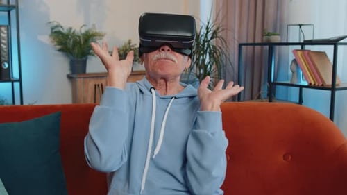 Senior Man Experiencing Virtual Reality on Couch