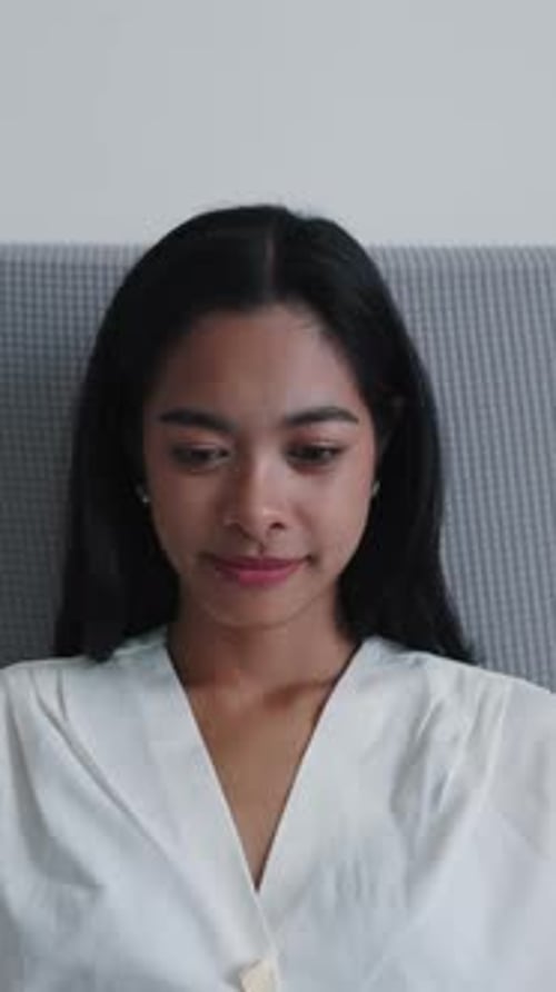 Woman Using Laptop on Couch Inside Home