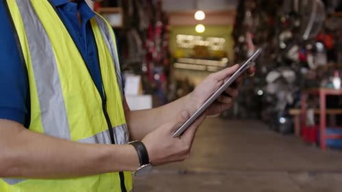 Close up engineering is using tablet in factory