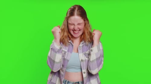 Excited Woman Cheering and Celebrating Success on Green Screen