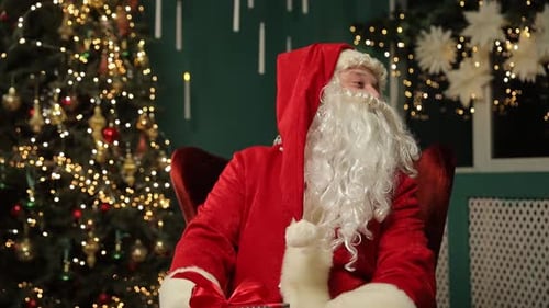 Santa Claus sitting with a Christmas tree