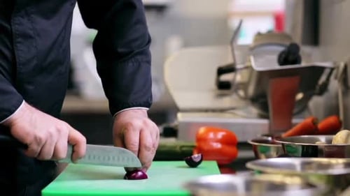 Chef Cutting Red Onion in Commercial Kitchen