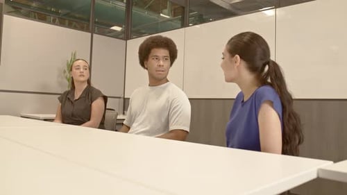 African American male, Arab American female and caucasian female in their 20's in a meeting with sta