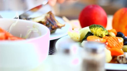 Person Eating Fish and Vegetables at Table
