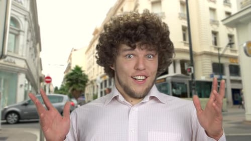 Man Expresses Shock and Surprise on City Street