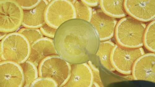Fresh Orange Juice Poured in Glass with Citrus Slices