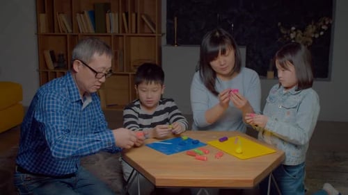 Family Creating Together with Clay Indoors at Home