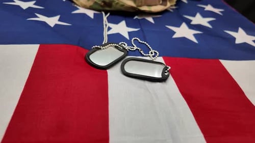 Military Helmet and Dog Tags on American Flag