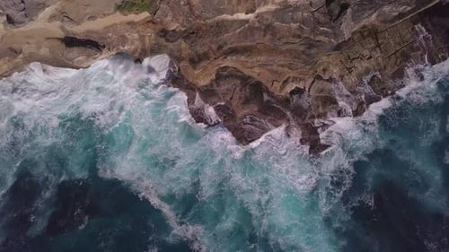 Top down aerial view of rock beach deep blue ocean waves amazing and beautiful video tropical sea in