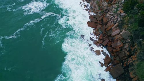 Top View Stormy Ocean Breaking Coastal Stones with White Foam. Aerial Foamy