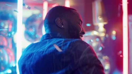 Man Celebrates with Confetti in Nightclub Atmosphere