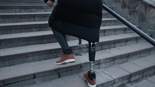 Adult with Prosthetic Leg Climbs Urban Stairs