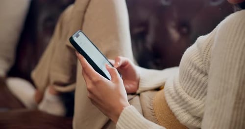 Person Using Smartphone on Sofa Close Up