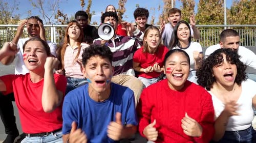 Enthusiastic Sports Fans Cheering and Celebrating Victory in Stadium Bleachers