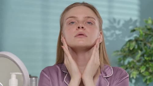 A Young Woman Touches Her Cheeks Worrying About Dryness or Oily Skin Woman Without Makeup with