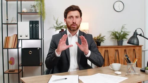 Professional Man Talking at Desk in Office Environment